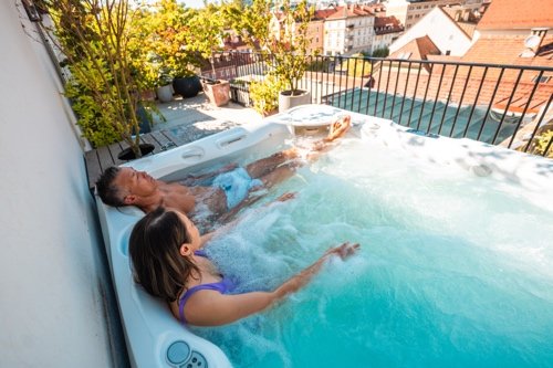 Couple relaxing in a rooftop hot tub